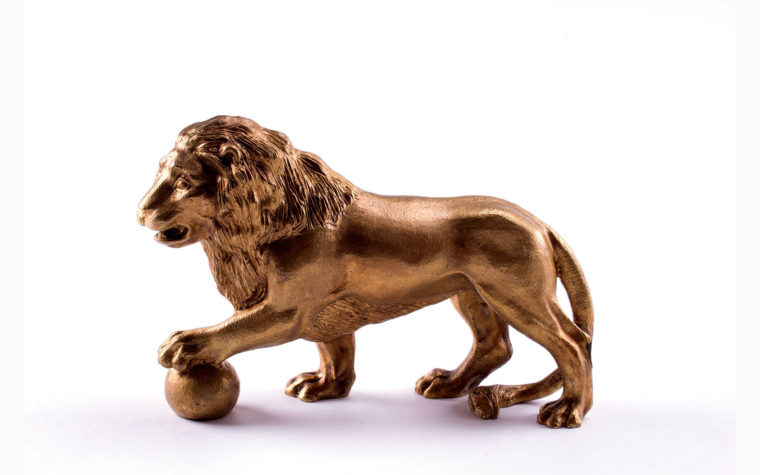 Bronze statuette Lion with paw on the ball (left)
